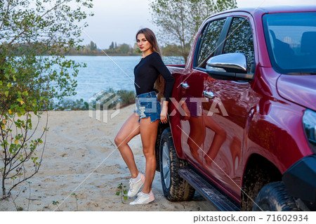 Girl posing near the car Girl posing near the car 71602934