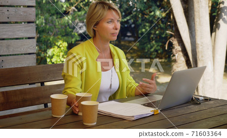 workaholic woman working on laptop in cafe outdoors with three cups of coffee workaholic woman working on laptop in cafe outdoors with three cups of coffee 71603364