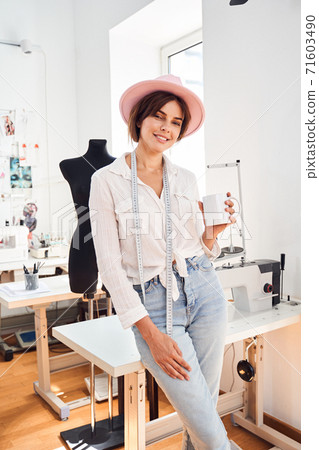 Seamstress smiling at camera Seamstress smiling at camera 71603490