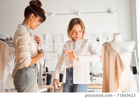 Client trying on an unfinished shirt Client trying on an unfinished shirt 71603623