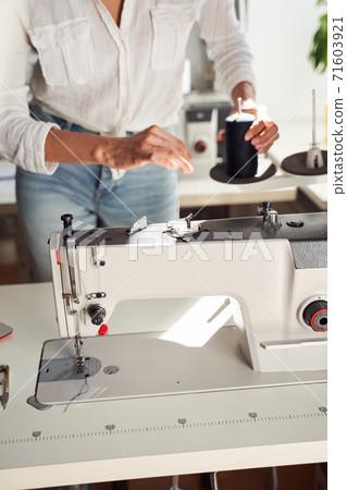 Woman seamstress sewing on sewing machine Woman seamstress sewing on sewing machine 71603921