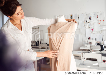 Woman working with mannequin Woman working with mannequin 71603955