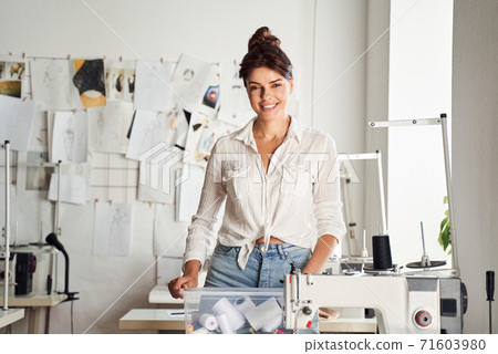 Seamstress holding a box of threads Seamstress holding a box of threads 71603980