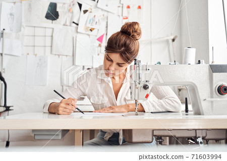 Designer drawing new sketches 71603994