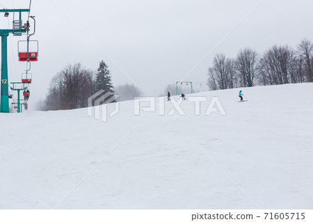 People skiing on a slope. People skiing on a slope. 71605715