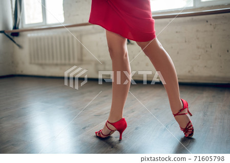 Woman wearing heels performing latina dance routine 71605798