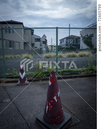 Planned road expansion site surrounded by a fence 71605799