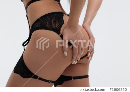 Faceless seductive woman with hands on buttocks 71606250
