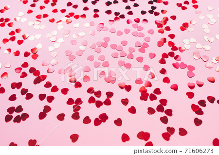 Romantic pink backround with red foil hearts 71606273