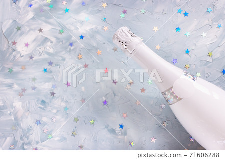 White champagne party bottle and stars confetti 71606288