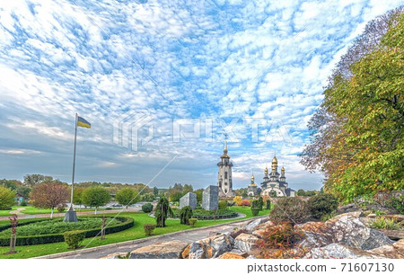 view of the landscape park with the Orthodox Christian Church of St. Eugene and the giant flag of Ukraine. Buki, Ukraine 71607130