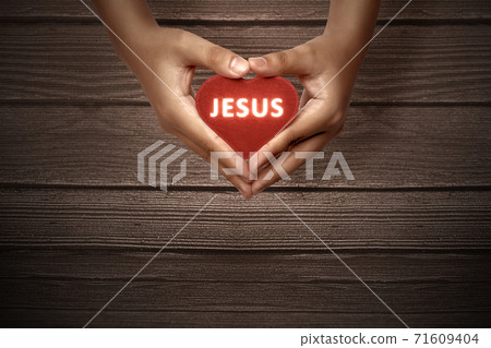 Human hands showing red heart with Jesus text Human hands showing red heart with Jesus text 71609404