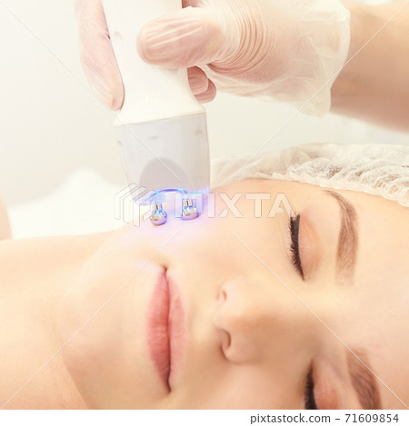 Light therapy procedure. Heal beauty treatment. Woman facial device. Anti age and wrinkle 71609854