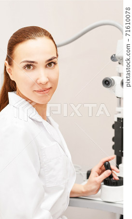 Eye ophthalmologist exam. Eyesight recovery. Astigmatism check concept. Ophthalmology diagmostic device. Beauty girl portrait in clinic Eye ophthalmologist exam. Eyesight recovery. Astigmatism check concept. Ophthalmology diagmostic device. Beauty girl portrait in clinic 71610078
