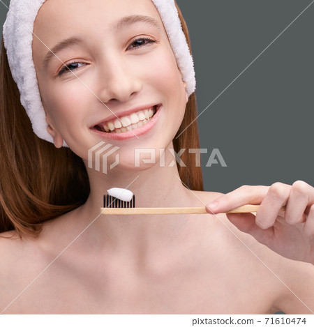 Girl hold toothbrush with toothpaste. Oral home routine Girl hold toothbrush with toothpaste. Oral home routine 71610474