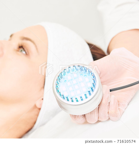 Skincare cosmetology facial procedure. Beauty woman face. Blue light medical 71610574
