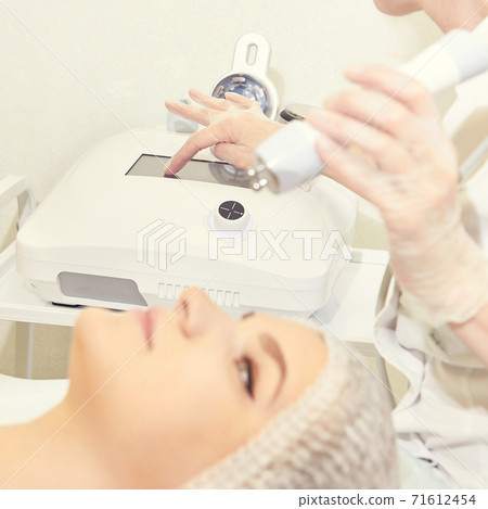 Facial micro current cosmetology procedure. Beauty technology treatment. Woman face therapy Facial micro current cosmetology procedure. Beauty technology treatment. Woman face therapy 71612454