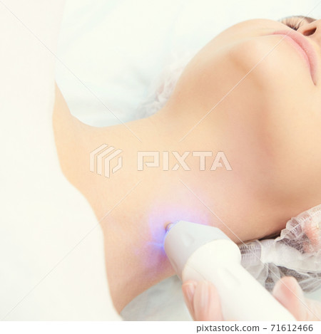 Light infrared therapy. Cosmetology head procedure. Beauty woman face. Cosmetic Light infrared therapy. Cosmetology head procedure. Beauty woman face. Cosmetic 71612466