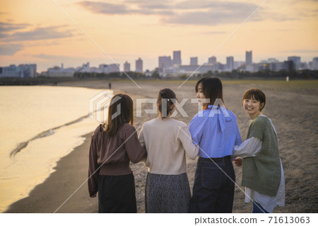 四名婦女在黃昏時沿著海邊散步 四名婦女在黃昏時沿著海邊散步 71613063