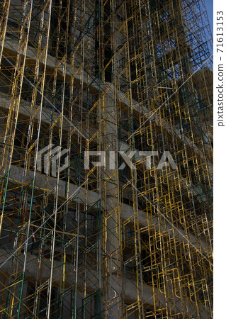 Scaffolding building frame on a building 71613153