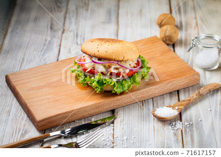 Side view on hamburger with sauerkraut and lettuce 71617157