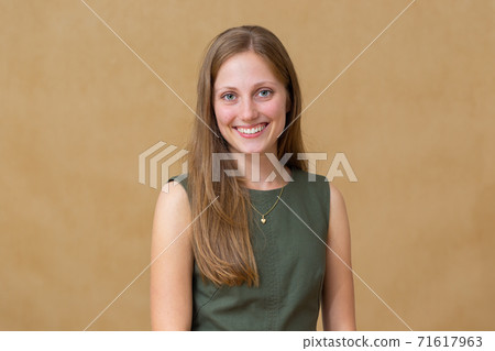 Young blonde woman smiling to the camera in studio 71617963