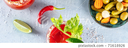 Bloody Mary panorama. Cocktail, shot from above with a red hot pepper, lime, and pickles Bloody Mary panorama. Cocktail, shot from above with a red hot pepper, lime, and pickles 71618926