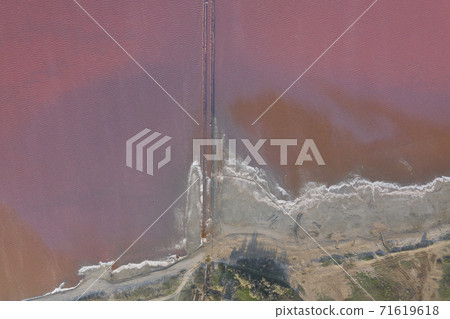 High angle drone view of pink lake where salt is extracted, Sasyk Sivash lake in Crimea High angle drone view of pink lake where salt is extracted, Sasyk Sivash lake in Crimea 71619618