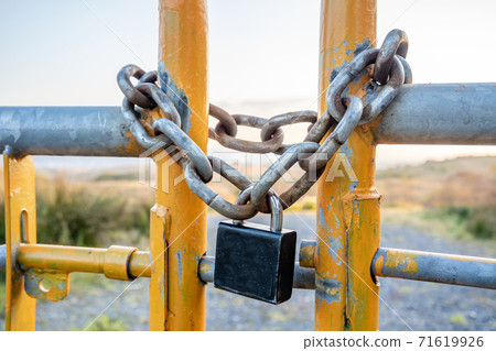 Padlock and chain at gate in wild Ireland 71619926
