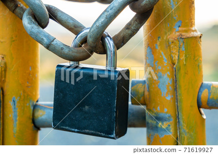 Padlock and chain at gate in wild Ireland 71619927