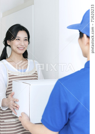 Woman receiving courier Woman receiving courier 71620233