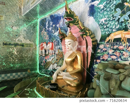 Buddha protected by the hood of the mythical serpent (Naga) at U Min Thonze temple in Sagaing city, Myanmar 71620634