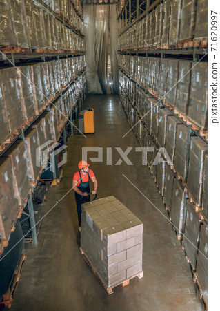 View of a person in a storage compartment with lots of containers on the shelves 71620997