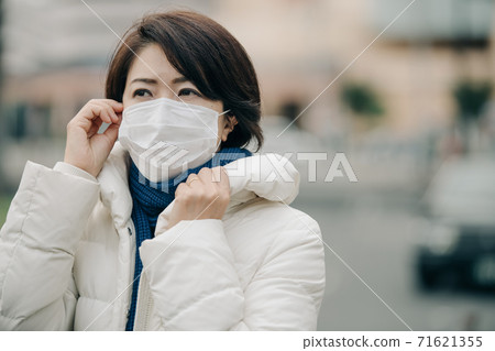 A winter woman wearing a mask, down coat and winter clothes 71621355