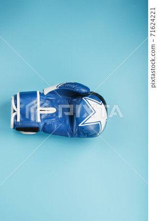 Blue Boxing glove on a blue background, free space. 71624221