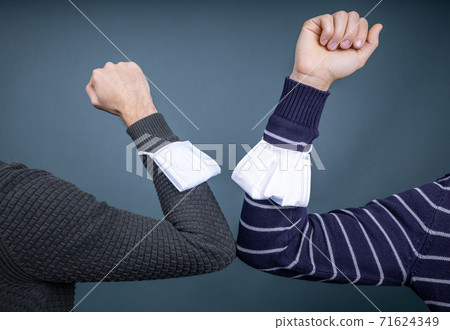 two people greeting each other with elbows two people greeting each other with elbows 71624349