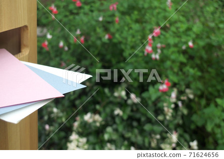 Letter posted on a wooden mailbox in the garden 71624656