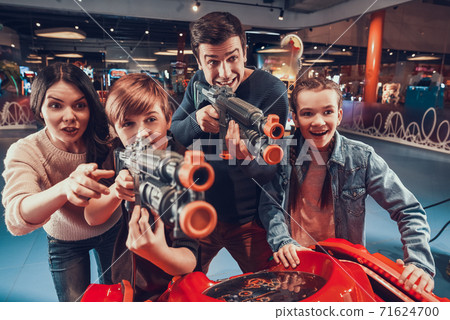 A young family came together to video games room. A young family came together to video games room. 71624700