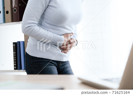 Woman in strict clothes and severe abdominal pain. 71625164