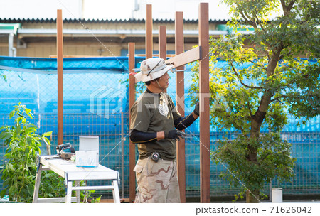 Carpenter making a fence Carpenter making a fence 71626042