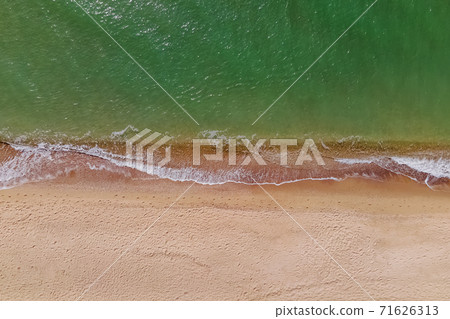 Aerial top view of the beach with sand and small waves Aerial top view of the beach with sand and small waves 71626313