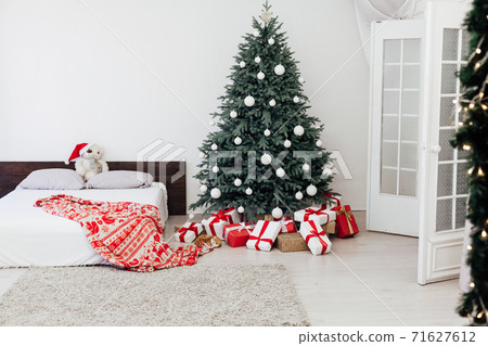 Christmas tree with gift decor bedroom with bed new year feast winter background Christmas tree with gift decor bedroom with bed new year feast winter background 71627612