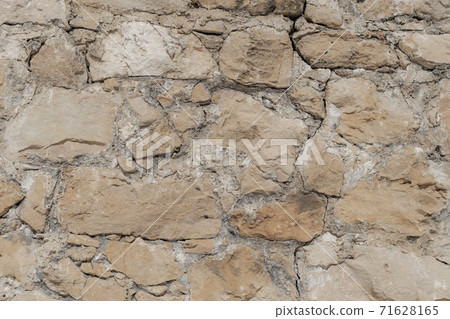 Construction background from a wall of stonework. The concept of strength for centuries Construction background from a wall of stonework. The concept of strength for centuries 71628165
