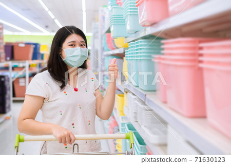 Women waring face mask shopping in supermarket self protection from coronavirus(Covid-19). Women waring face mask shopping in supermarket self protection from coronavirus(Covid-19). 71630123