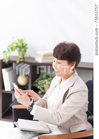 Woman operating a smartphone 71631757