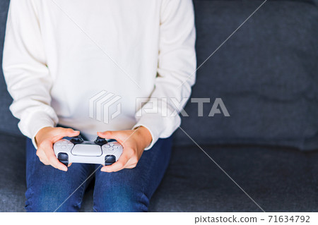 Teenager playing with a game controller [e-sports] 71634792