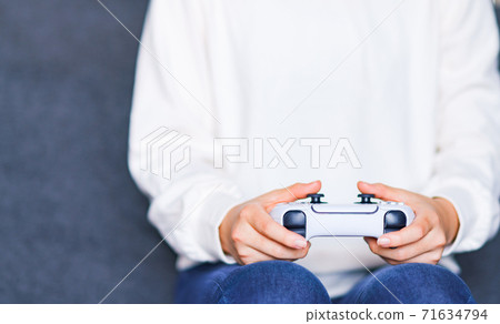 Teenager playing with a game controller [e-sports] 71634794