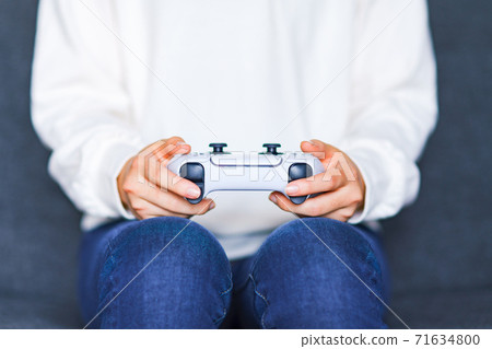 Teenager playing with a game controller [e-sports] 71634800