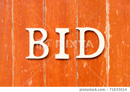 Alphabet letter in word bid on old red color wood plate background Alphabet letter in word bid on old red color wood plate background 71635014