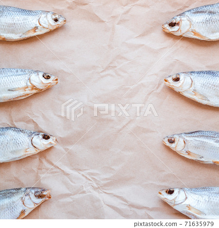 Dried fishes template banner on craft paper background with empty space for text. Flat Salted roach web cover backdrop. Seafood snack poster, decorative design. Fish square frame for promotion shop 71635979